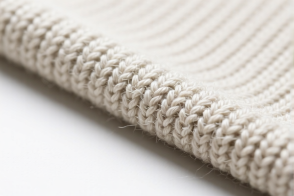 Artificial fiber warp knitted fabric